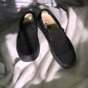 All black slip-on Vans
